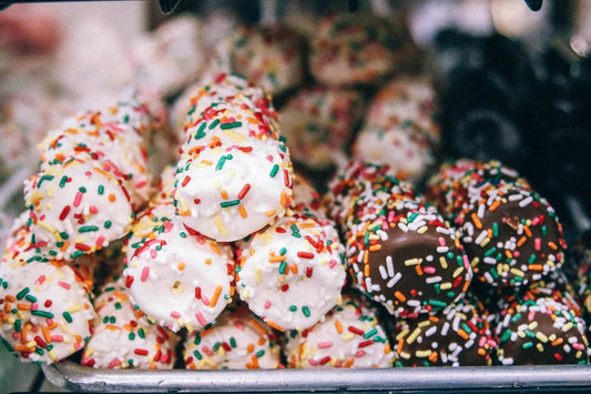 Marshmallows dipped in chocolate & rolled in rainbow sprinklers
